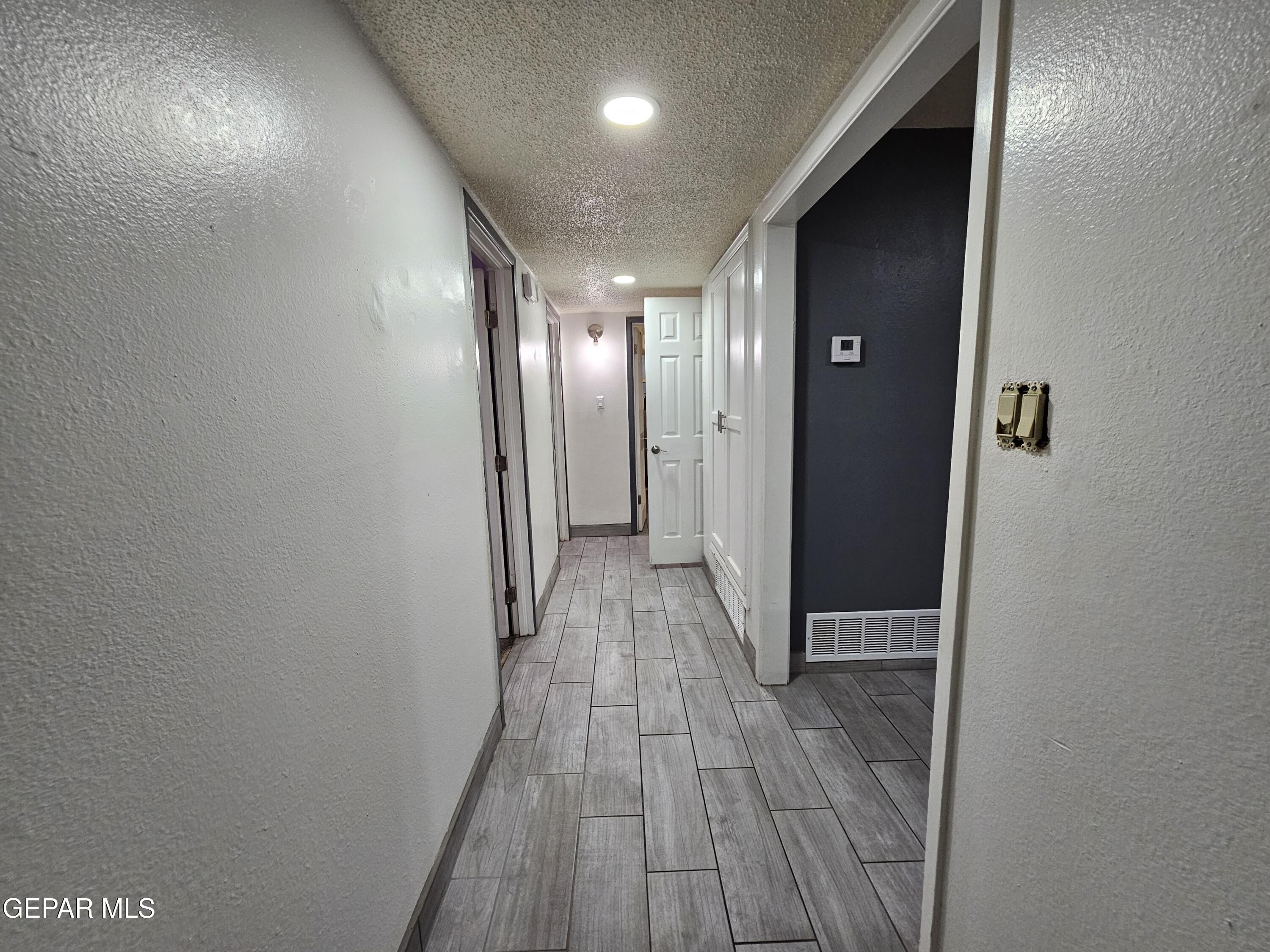 1400 San Andres Drive Las Cruces, NM 88007 - Photo 16 of 47 a view of hallway with wooden floor