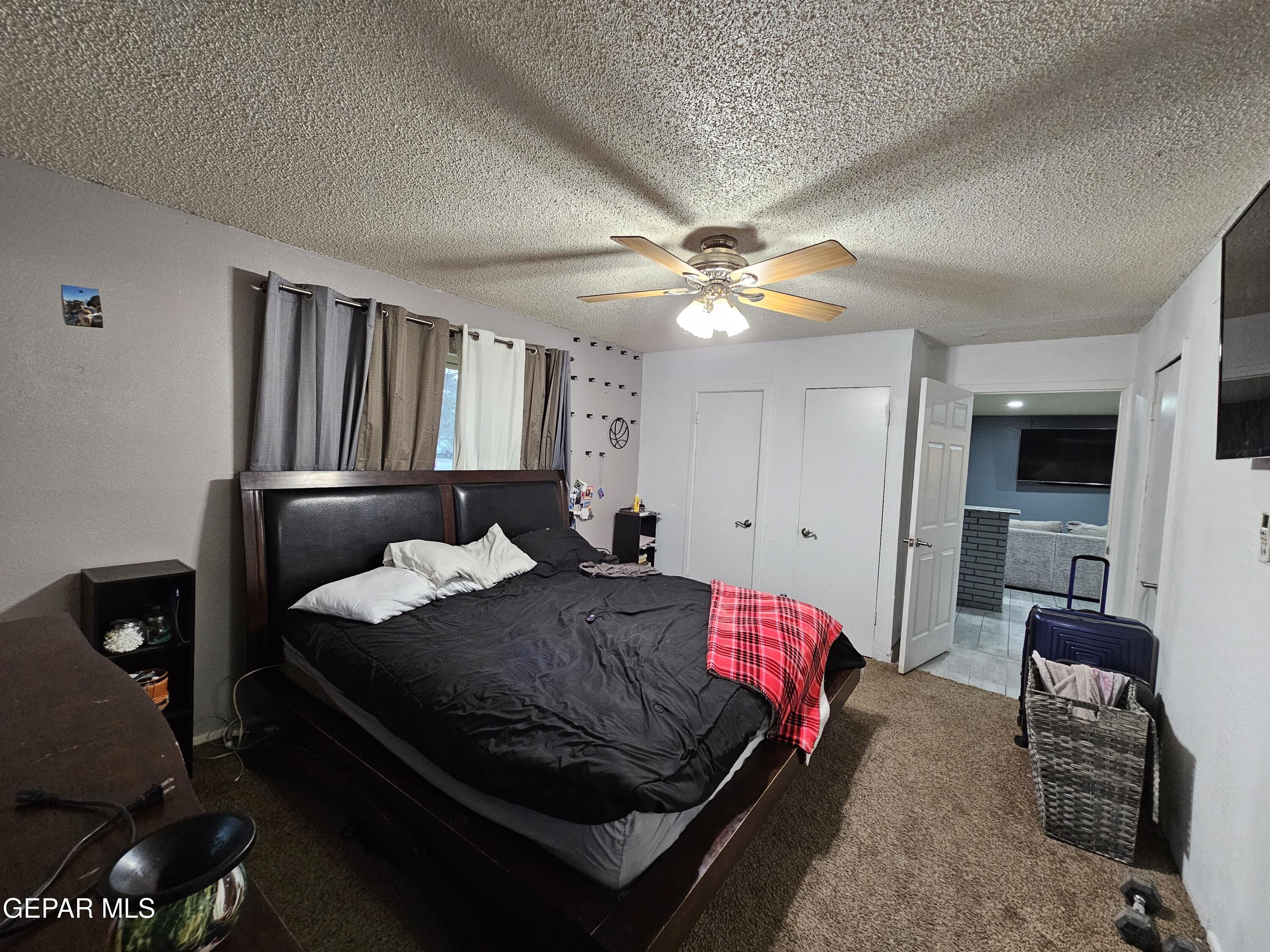1400 San Andres Drive Las Cruces, NM 88007 - Photo 21 of 47 a bedroom with a bed and a chandelier