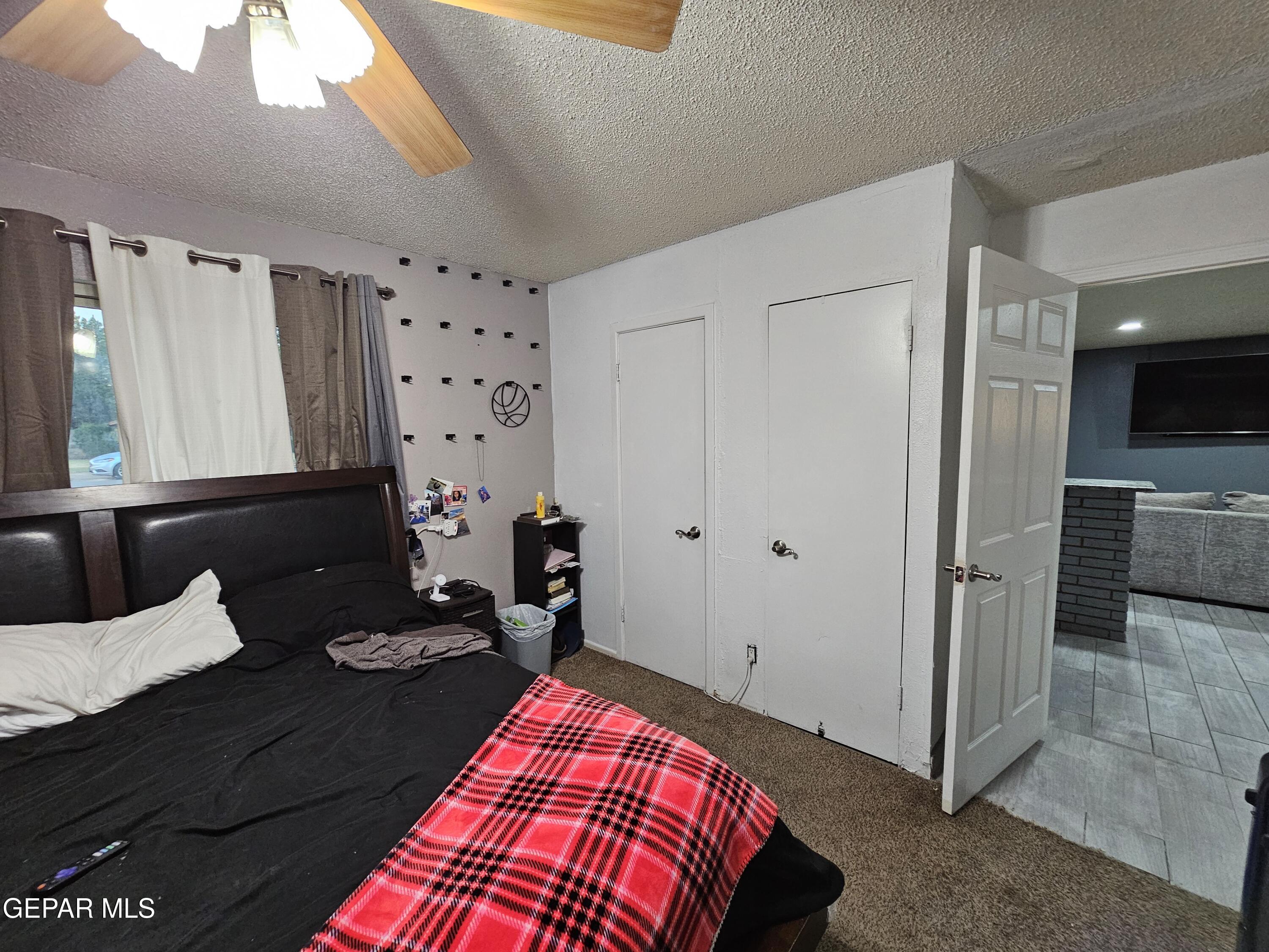 1400 San Andres Drive Las Cruces, NM 88007 - Photo 22 of 47 a bedroom with a bed and a mirror