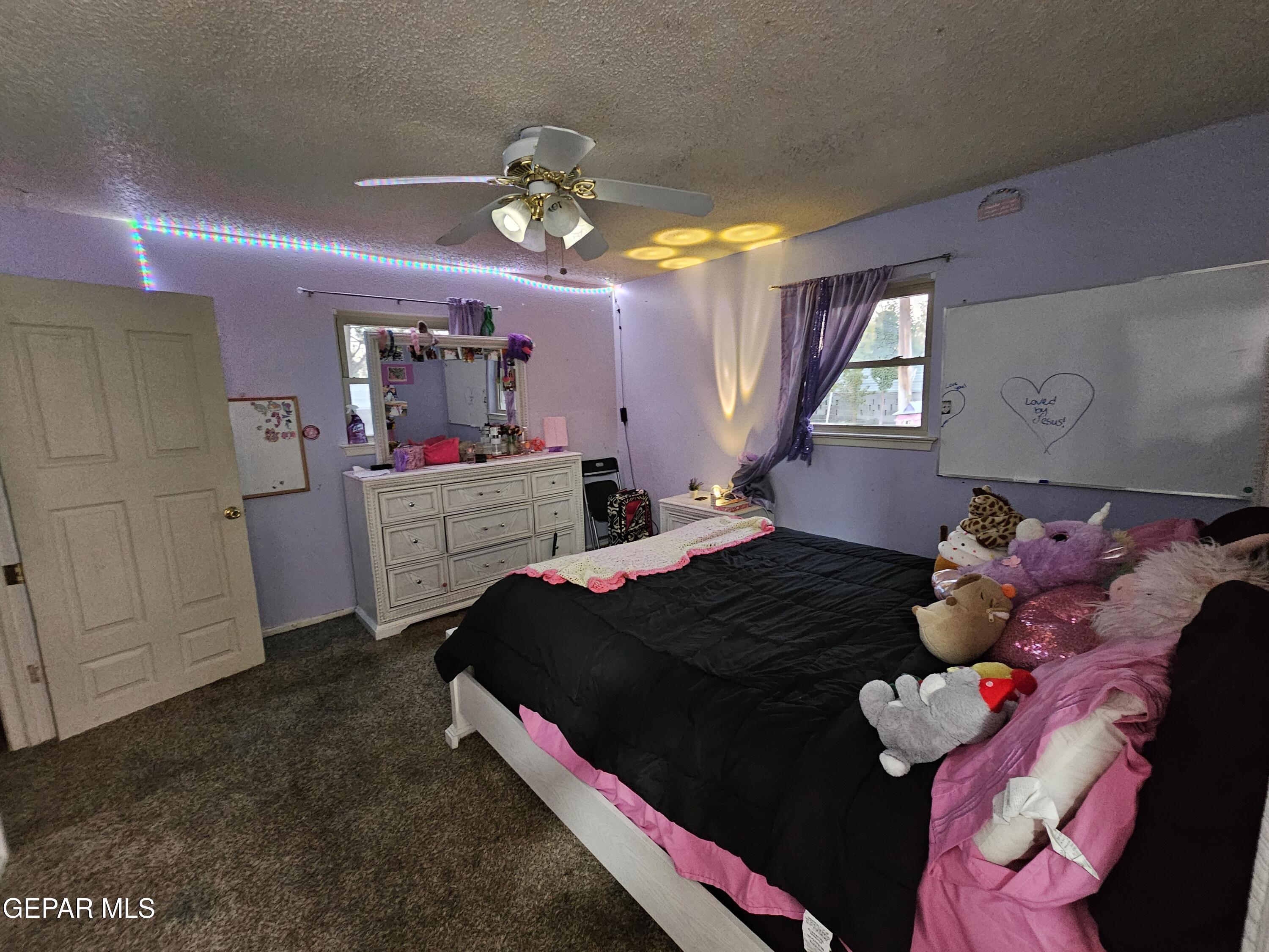 1400 San Andres Drive Las Cruces, NM 88007 - Photo 27 of 47 a bedroom with a bed and a chandelier