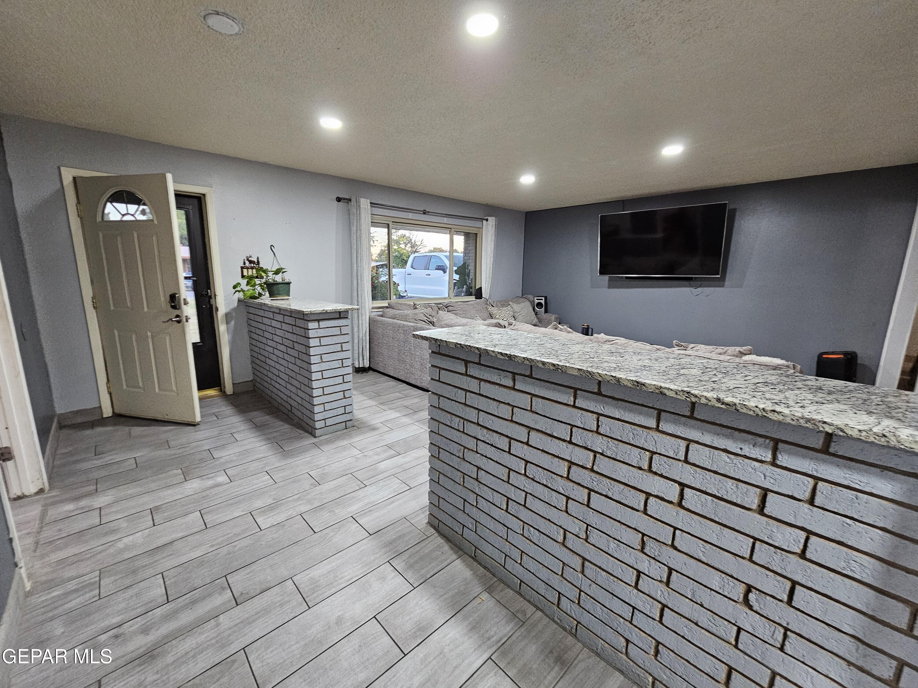 1400 San Andres Drive Las Cruces, NM 88007 - Photo 3 of 47 a living room with kitchen island granite countertop furniture and a fireplace