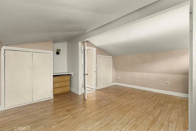 a view of empty room with wooden floor and sliding door