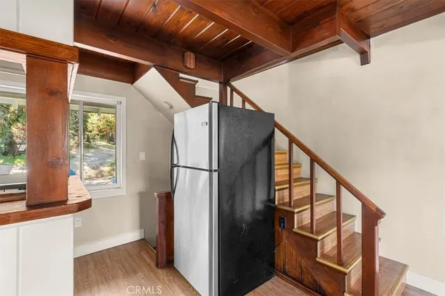 a view of kitchen with stainless steel appliances wooden floor
