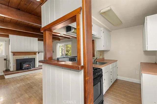 a kitchen with a stove top oven sink and cabinets