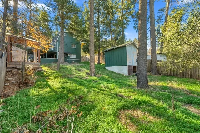 a view of a wooden house with a small yard