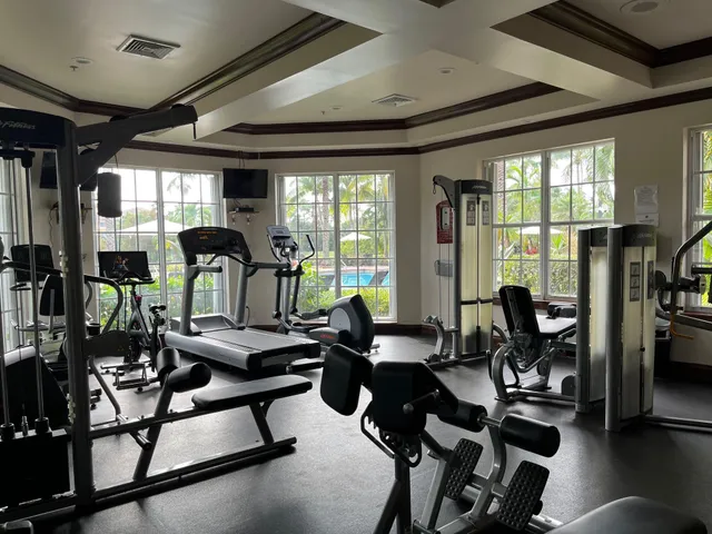 a room with lots of chairs and large windows