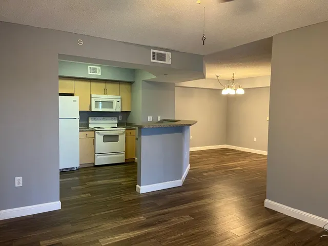 a view of kitchen with sink and wooden floor