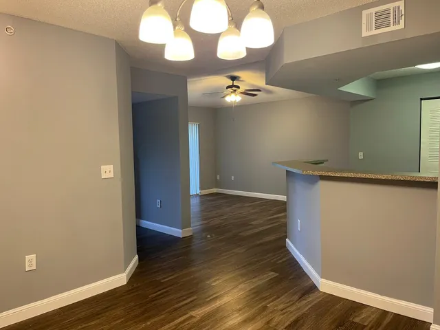 a view of a room with wooden floor