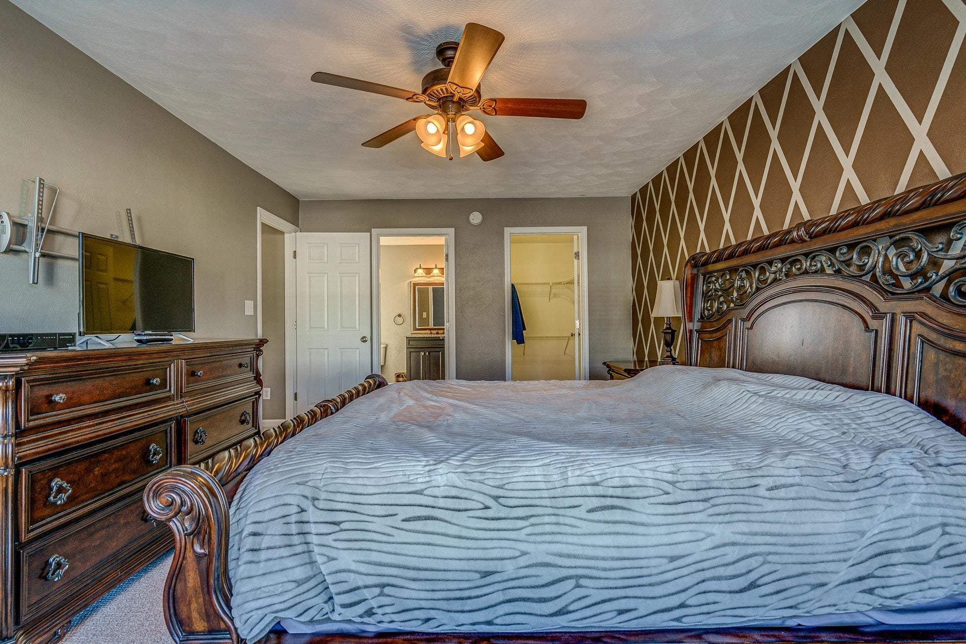 1745 Meadows Road Vinton, VA 24179 - Photo 22 of 38 a bedroom with a bed and a flat screen tv