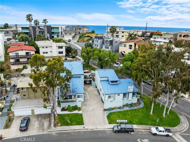 an aerial view of multiple houses with yard