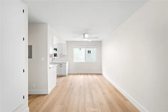 a view of a kitchen with a white cabinet and a stove top oven