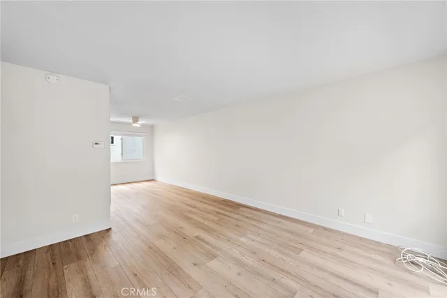 a view of an empty room and wooden floor