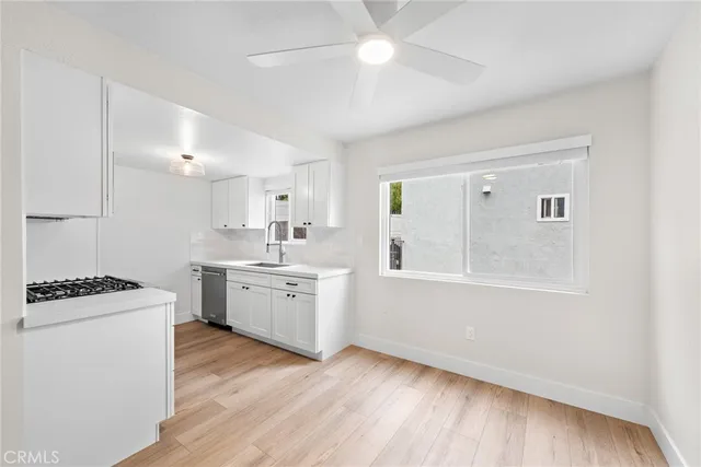 a kitchen with a stove a sink and a refrigerator