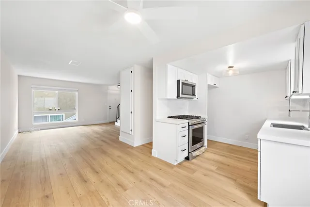 a kitchen with a stove a sink and a refrigerator
