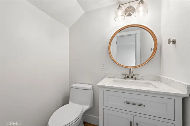 a bathroom with a sink a mirror and toilet