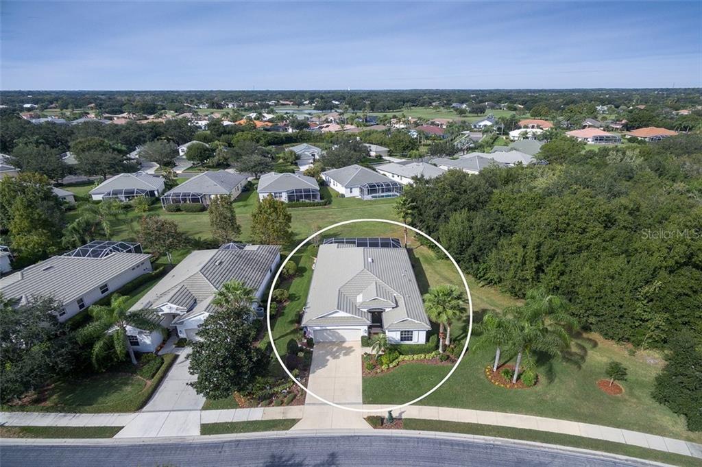 12130 Red Leaf Road Parrish, FL 34219 - Photo 1 of 1 an aerial view of a house with a garden and lake view