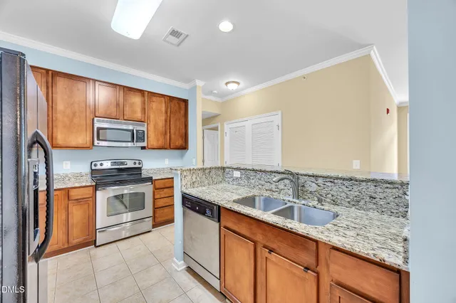 a kitchen with stainless steel appliances granite countertop a sink stove and oven