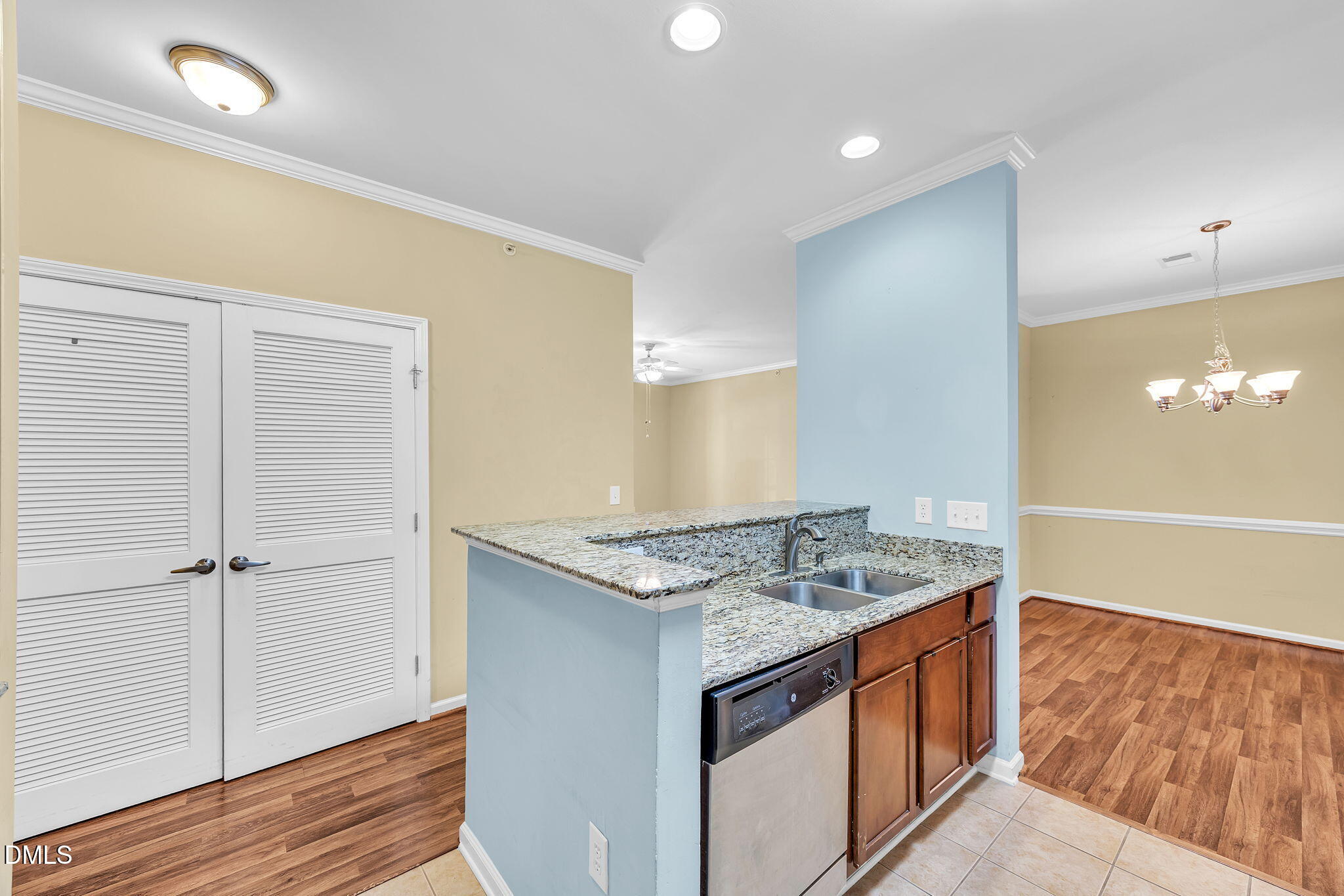 522 Weather Ridge Lane Cary, NC 27513 - Photo 16 of 31 a view of kitchen island a sink wooden floor and a chandelier