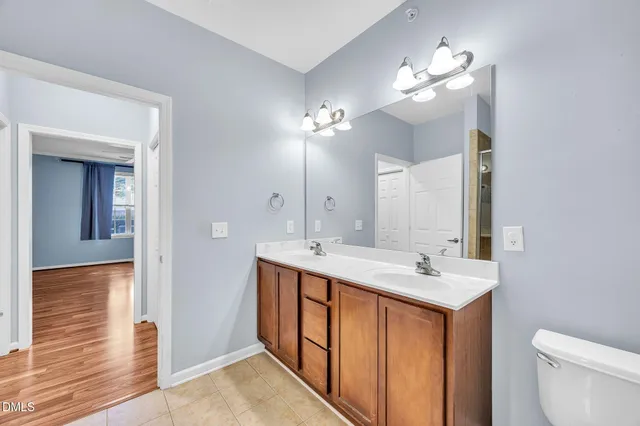 a bathroom with a double vanity sink and a mirror