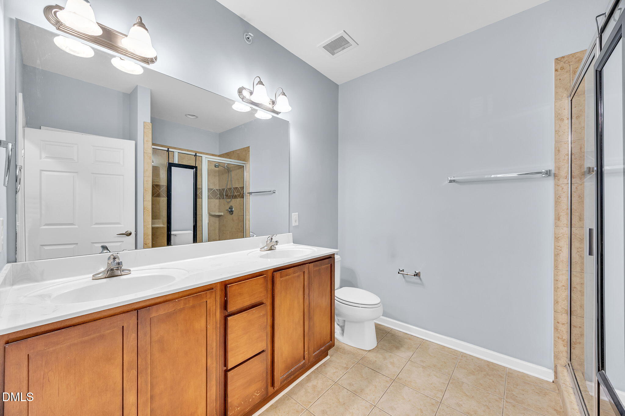 522 Weather Ridge Lane Cary, NC 27513 - Photo 20 of 31 a bathroom with a double vanity sink a toilet and a mirror