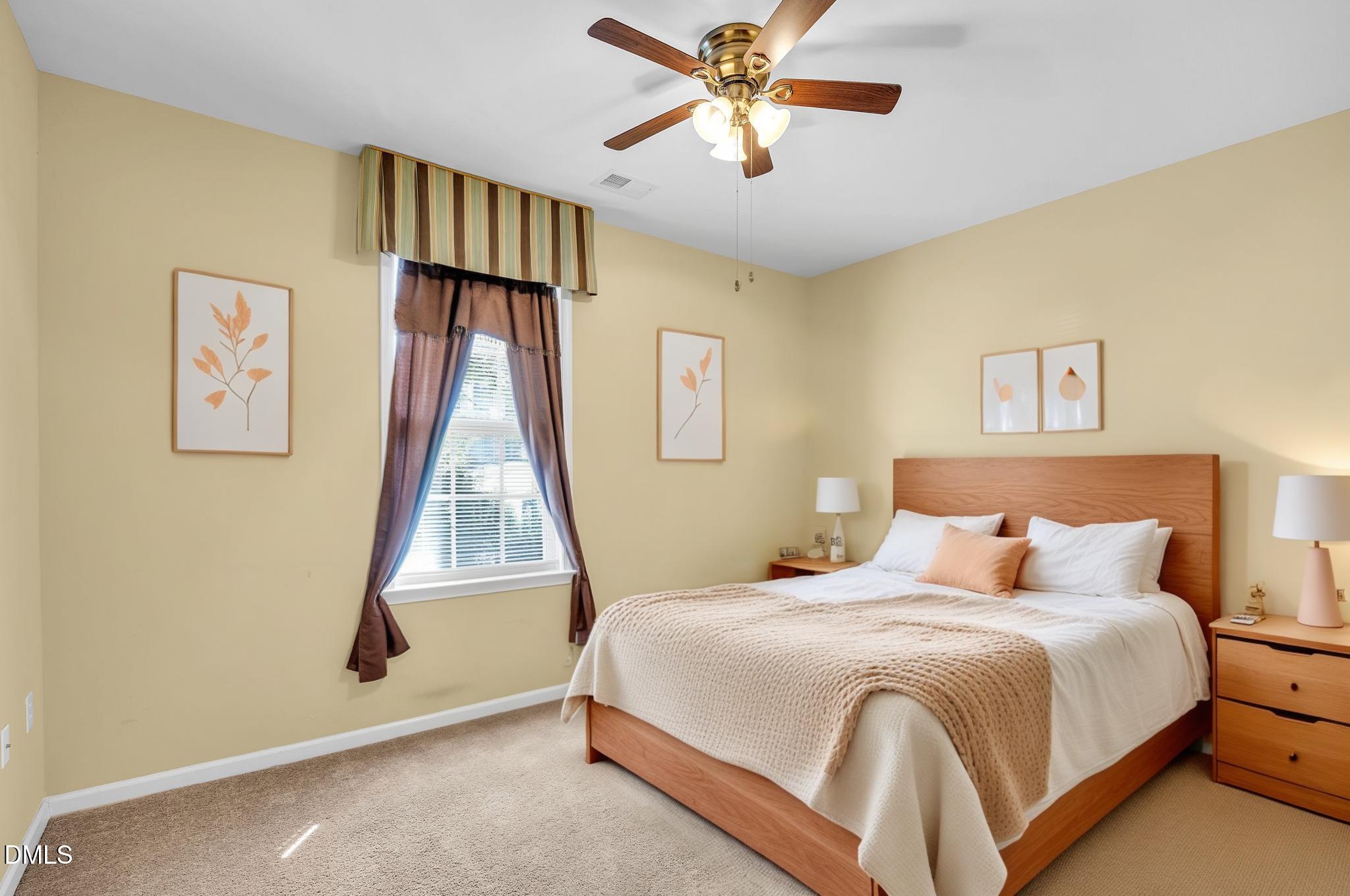 522 Weather Ridge Lane Cary, NC 27513 - Photo 3 of 31 a bedroom with a bed and a chandelier