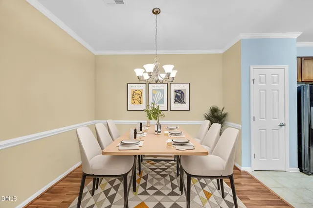 a view of a dining room with furniture and chandelier