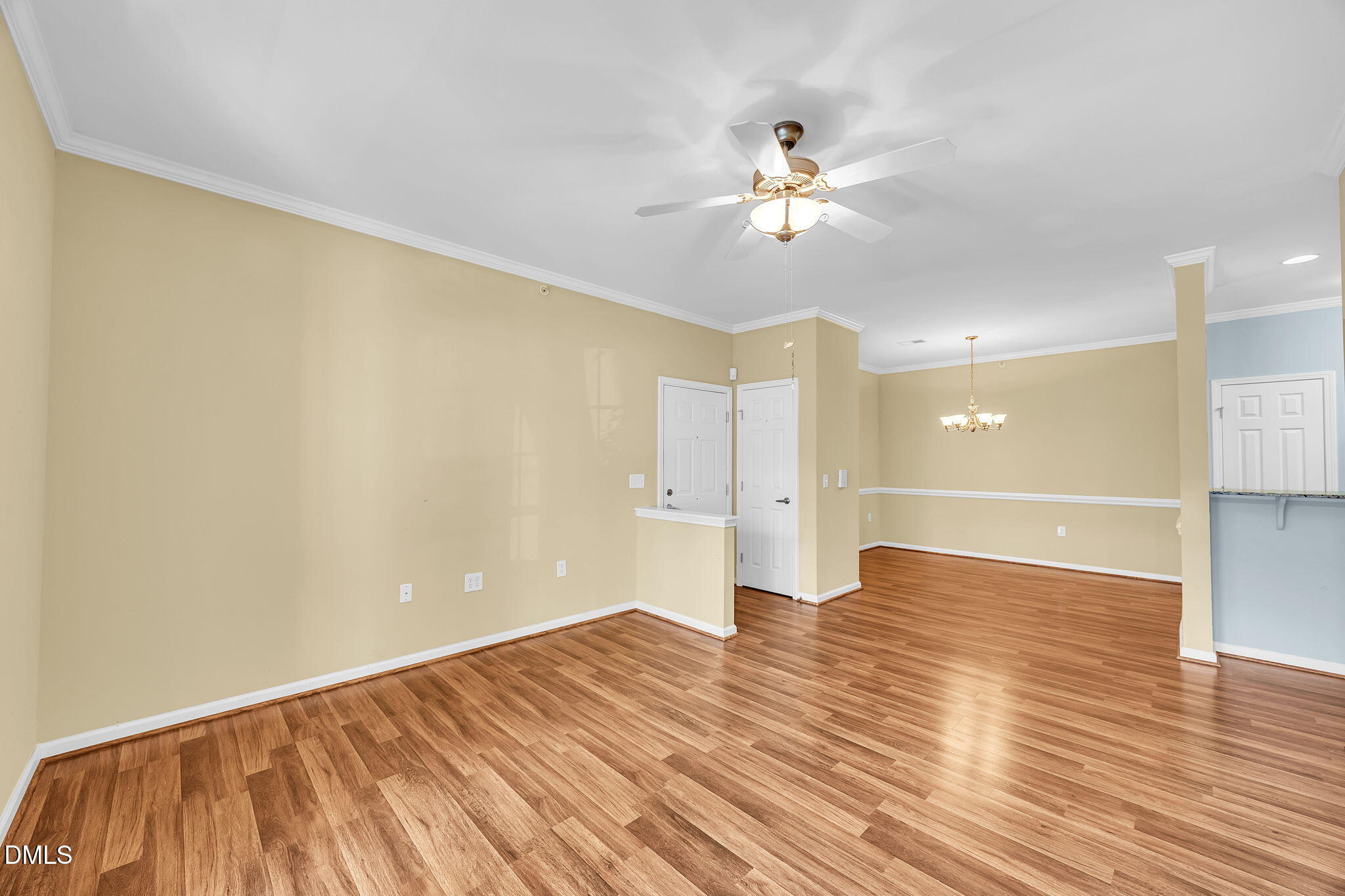 522 Weather Ridge Lane Cary, NC 27513 - Photo 6 of 31 a view of an empty room with wooden floor and a chandelier fan