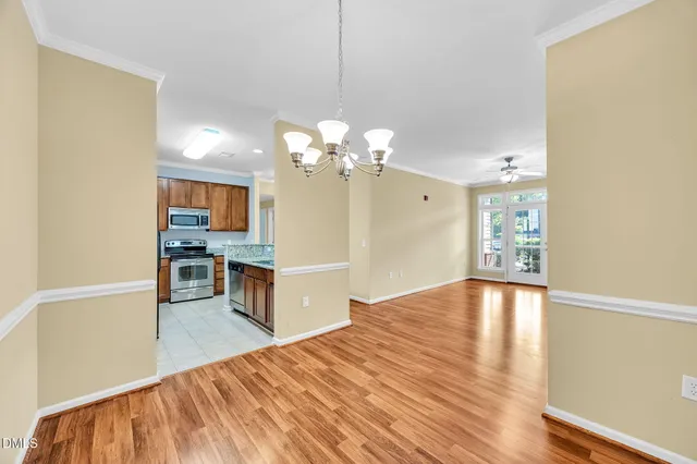 a view of a kitchen with cabinets and wooden floor