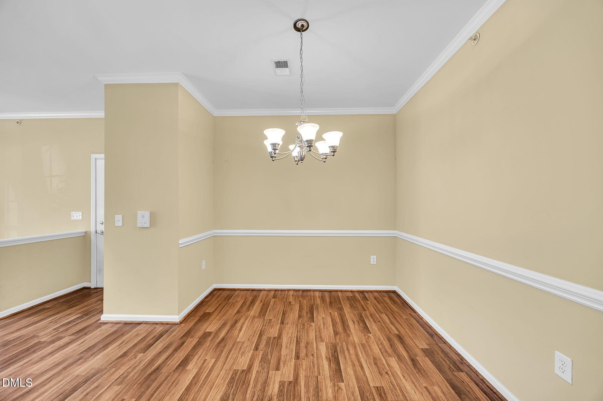 522 Weather Ridge Lane Cary, NC 27513 - Photo 9 of 31 a view of a room with wooden floor and chandelier