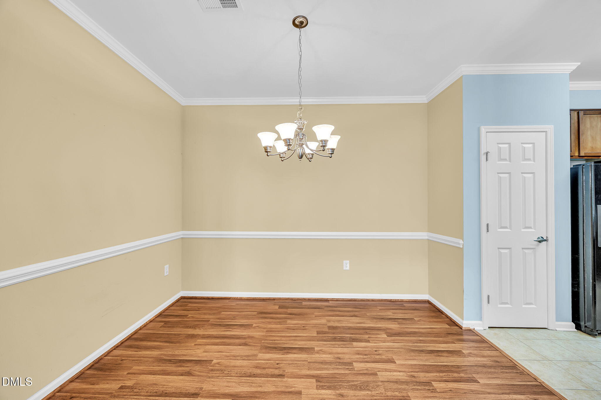 522 Weather Ridge Lane Cary, NC 27513 - Photo 10 of 31 a view of an empty room with chandelier fan and wooden floor