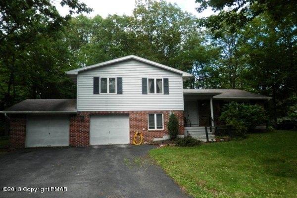 6 Cedar Road Mount Pocono, PA 18344 - Photo 1 of 18 a front view of a house with a yard and garage