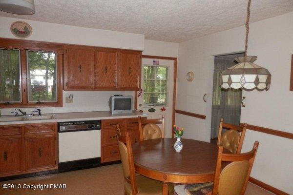 6 Cedar Road Mount Pocono, PA 18344 - Photo 8 of 18 a kitchen with a dining table chairs and granite counter space
