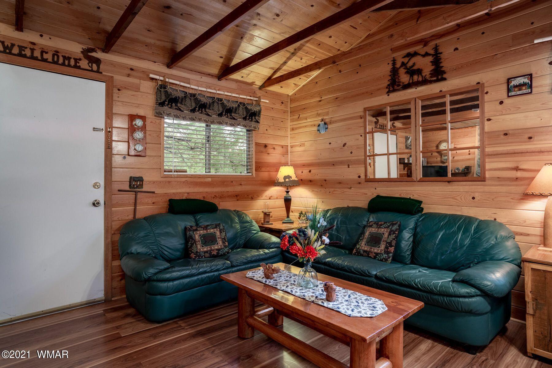 2876 Long Rifle Place Overgaard, AZ 85933 - Photo 1 of 13 a living room with furniture and a fireplace