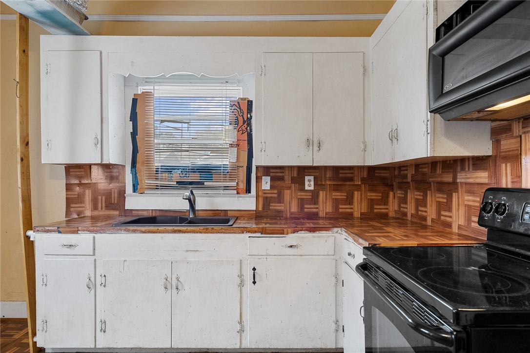 503 Hayes Street Anderson, SC 29624 - Photo 12 of 23 This kitchen offers functional cabinetry, a sink, and cooking appliances for daily living.
