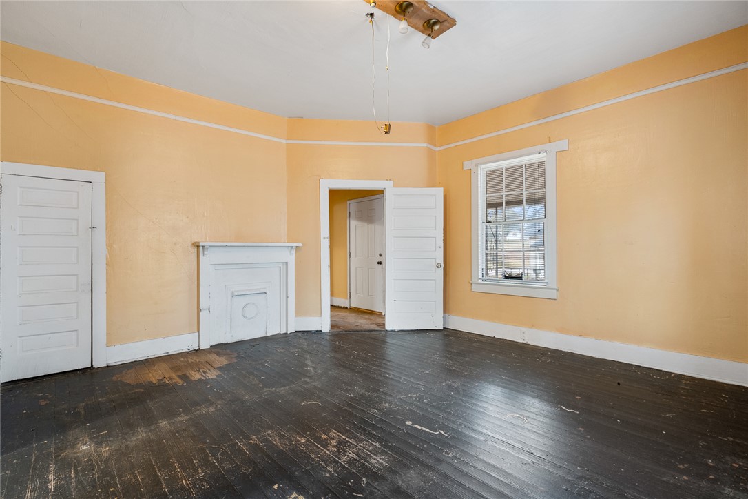 503 Hayes Street Anderson, SC 29624 - Photo 16 of 23 This living room features rich wood flooring, a charming fireplace, and a bright window.