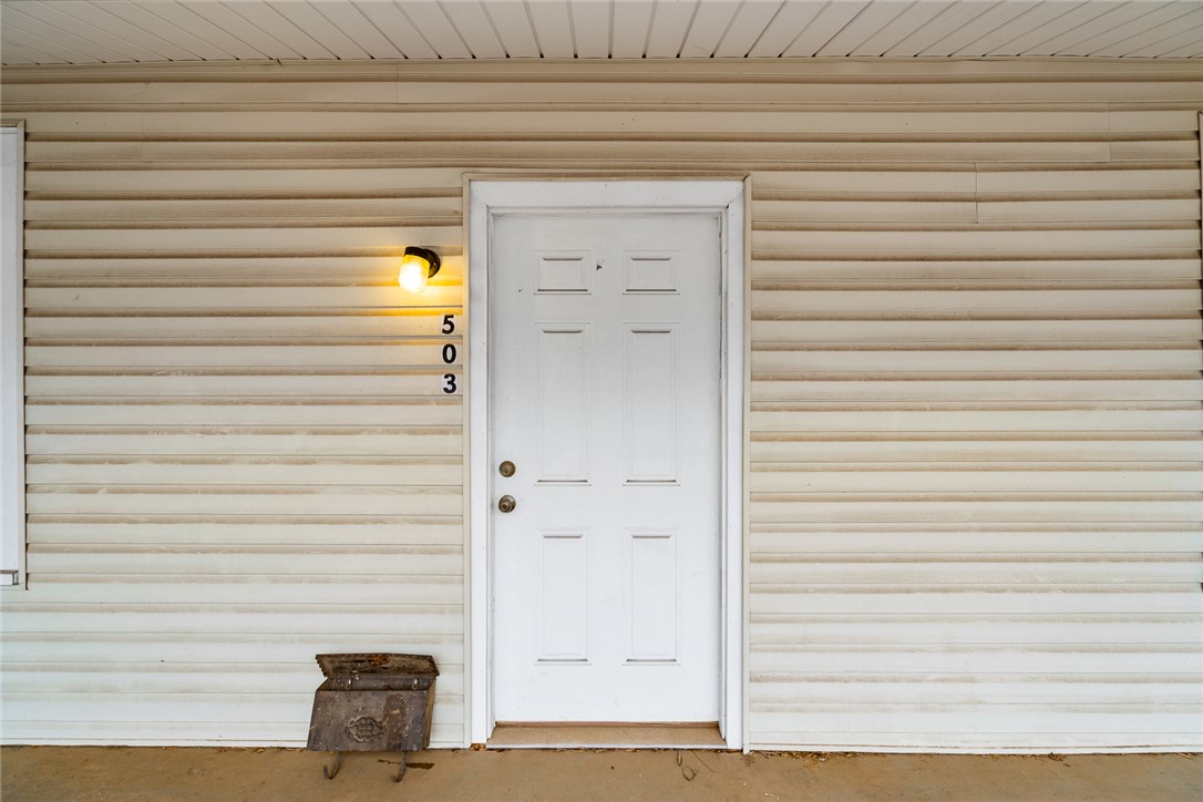 503 Hayes Street Anderson, SC 29624 - Photo 4 of 23 Welcome to a charming residence, featuring classic vinyl siding and a sturdy wooden door.