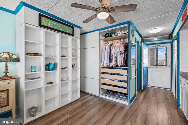 a view of a hallway with wooden floor and entryway
