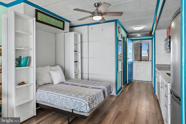 a bedroom with a large bed and a chandelier