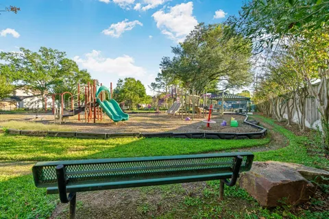 an aerial view of a house with a yard and a large garden