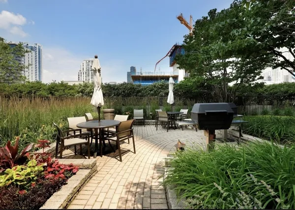 a view of a lake with a table and chairs in patio