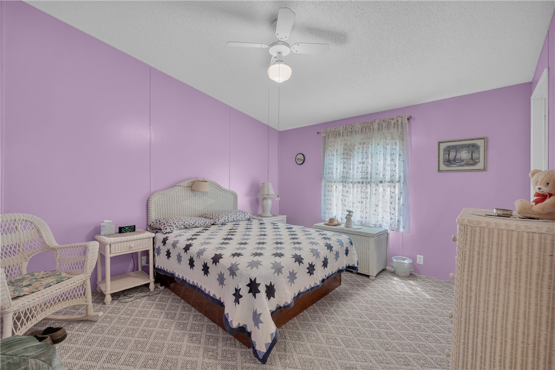 721 Cedar Crest Trail Walhalla, SC 29691 - Photo 24 of 47 A comforting bedroom space features a ceiling fan and patterned carpet, ideal for peaceful rest.