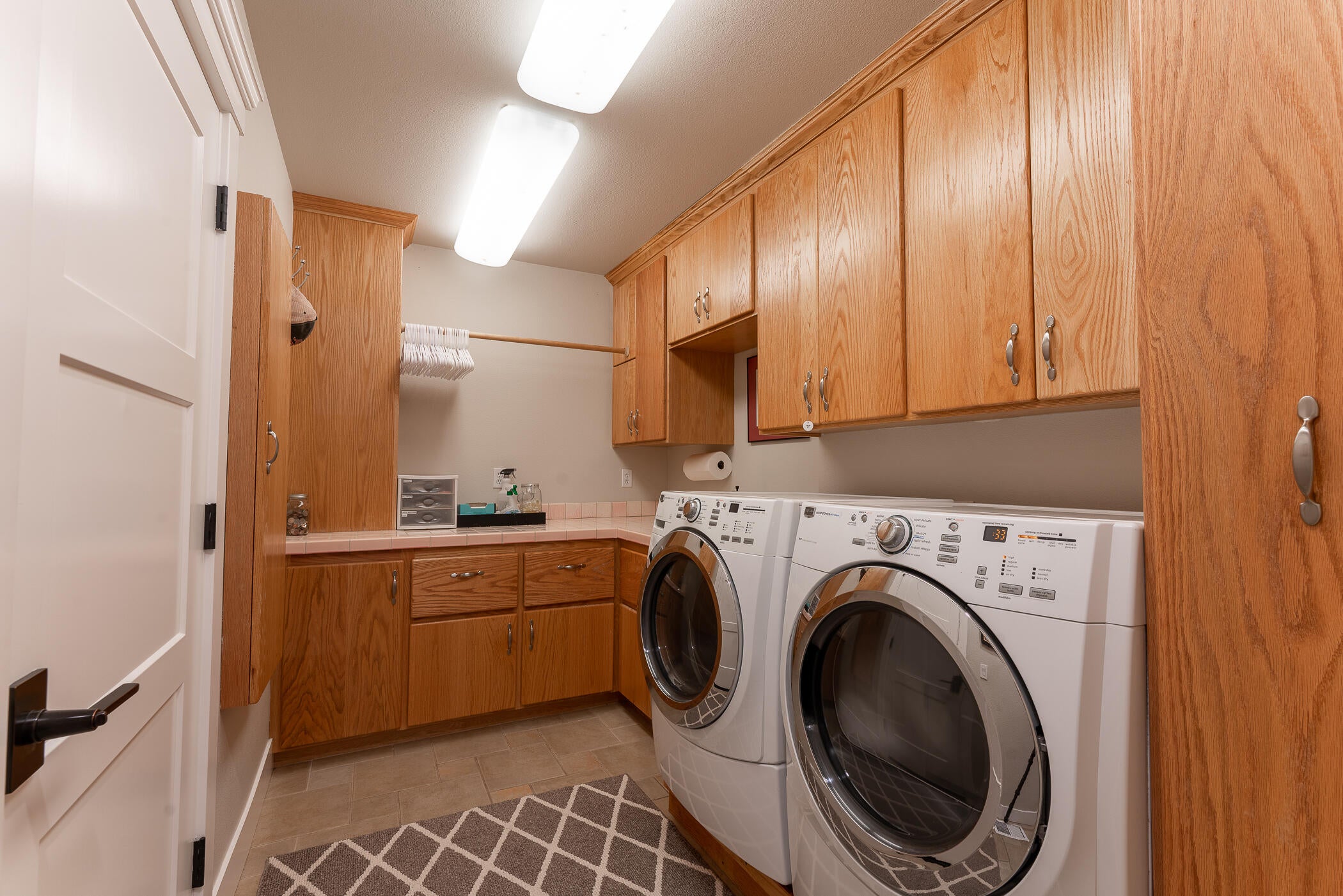 64300 Crosswinds Road Bend, OR 97703 - Photo 40 of 61 Laundry room on the main level between the garage and the hallway to the living space...so much storage space...good thing that Costco is just 10 minutes away!