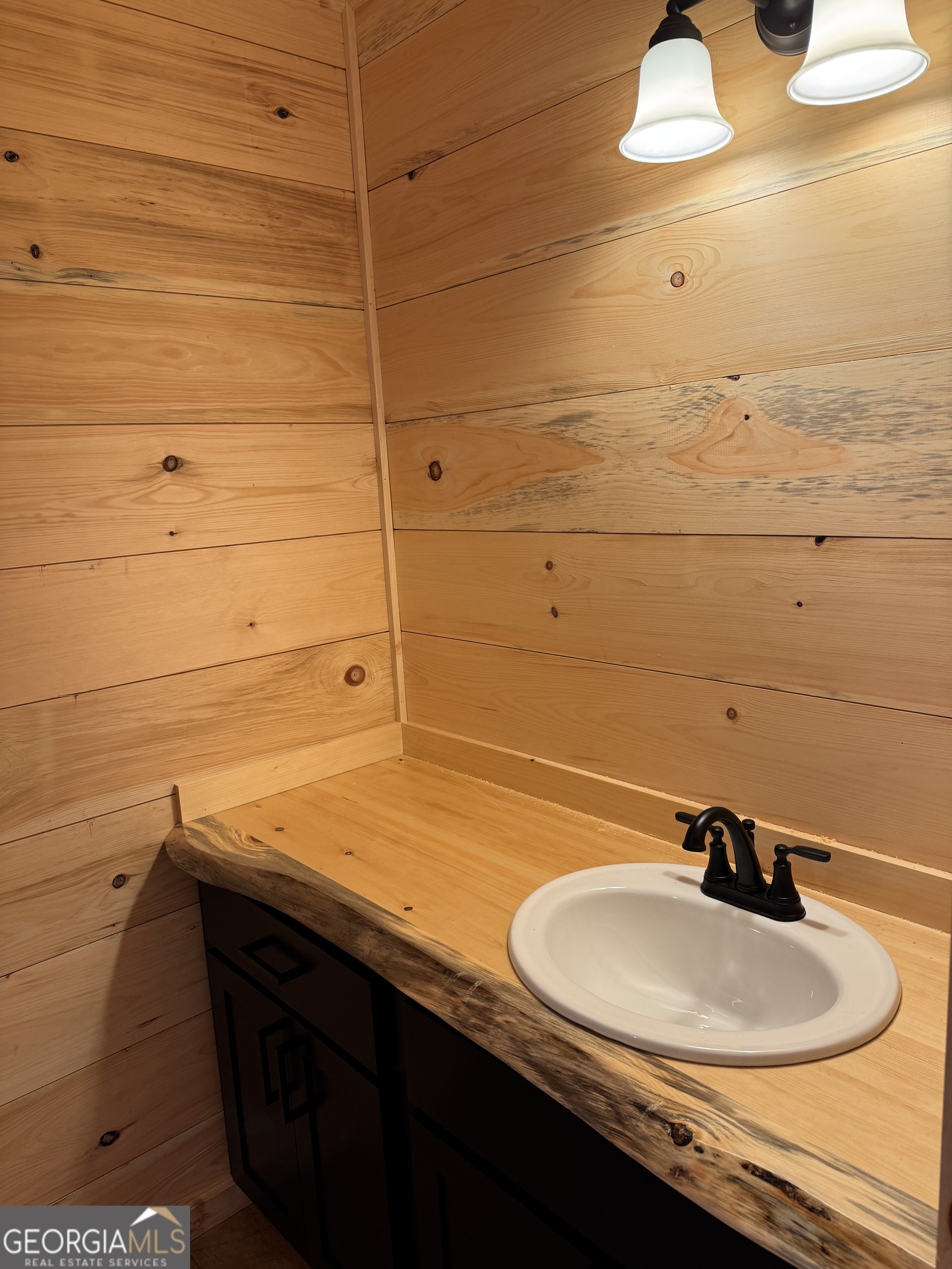 639 Moreland Drive Blue Ridge, GA 30522 - Photo 15 of 24 a bathroom with a sink and a mirror