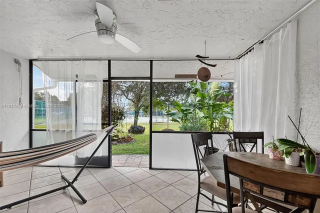 a living room with a table and chairs
