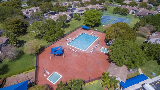 an aerial view of a house with a garden and swimming pool