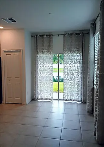 a view of a room with window and front door