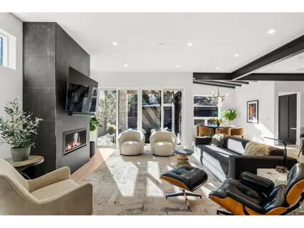a living room with fireplace furniture and a flat screen tv
