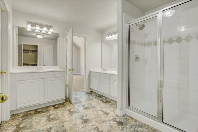 view of a bathroom with a shower and a sink