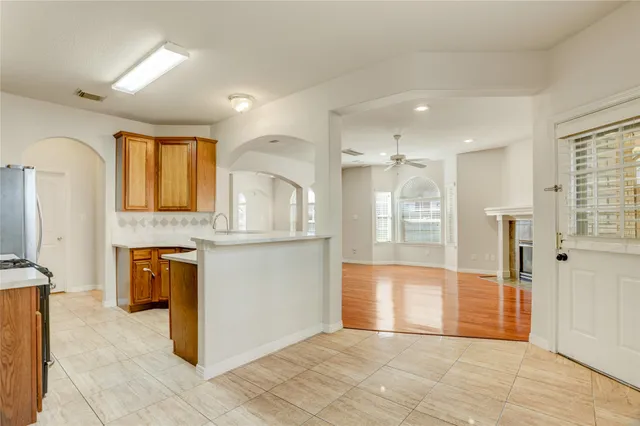 a view of a kitchen with a sink and a refrigerator