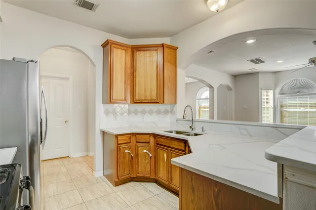 a kitchen with a sink cabinets and window